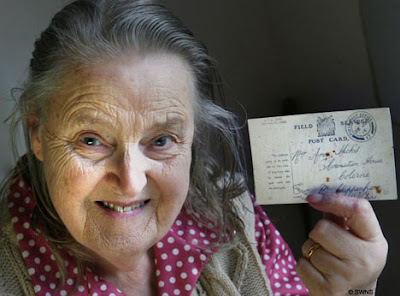 Amy Hicks with the postcard that has only just arrived - 90 years after it was sent!