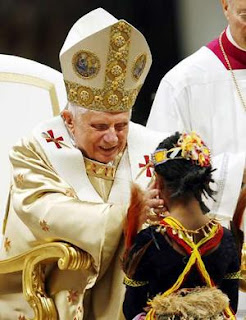 Pope Benedict XVI blesses a child at church sexy image