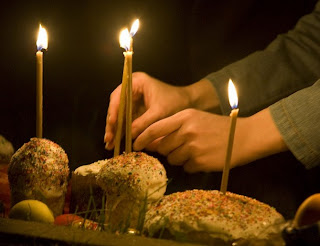 lighting candles on Easter bread at prayer hot picture