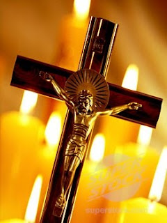 Jesus Christ on the golden cross with candles background Religious Christian photo