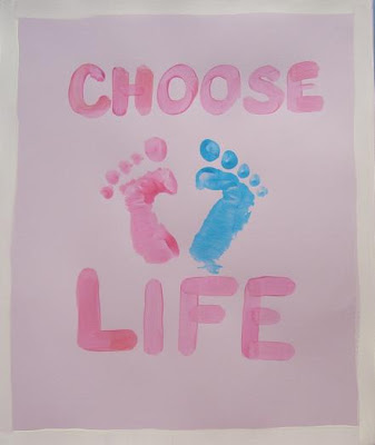 Painted sign with pink and blue foot prints that say Choose Life