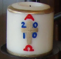 Miniature Paschal candle with cross reading 2010 and Alpha and Omega symbols