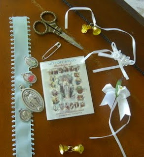 Scissors, ribbons, and medallions of Mary