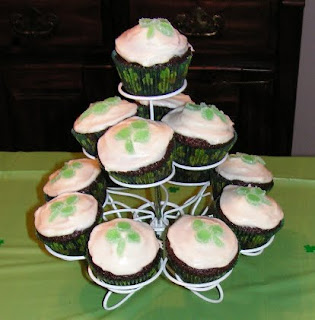 Cupcake tower with chocolate cupcakes with shamrock toppings