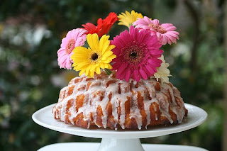 Bundt cake with icing and flowers on top