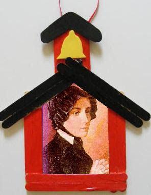 Wooden sticks painted and arranged as a schoolhouse with Saint Elizabeth Ann Seton's picture in the middle