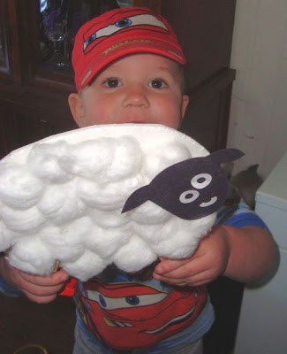 Child showing off sheep craft