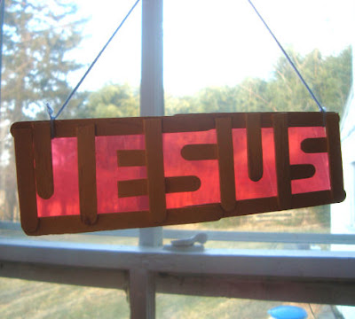 Jesus popsicle stick word art hanging in window