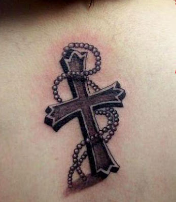 cross tattoos for women on back. Alternatively, you can choose to have rosaries around the band cross tattoo 