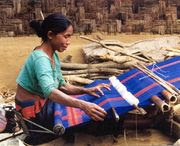 A woman weaving. Textile work has historically been a female occupation in some cultures.