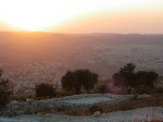 Sunset over Palestinian village and Israeli settlement