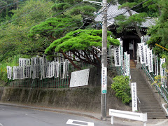 White Banners in front of little Buddha Shrine
