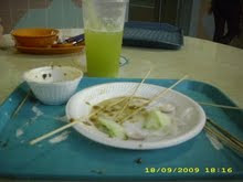 Finished eating satay and drinking sugarcane juice