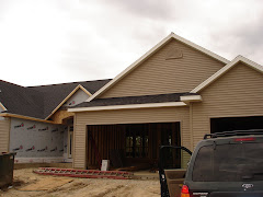 Garage siding is complete with half round vent