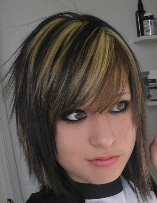 dark brown hair with orange highlights. Hair is cut in long layers and
