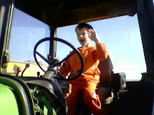 spencer having fun in a tractor at the corn maze.