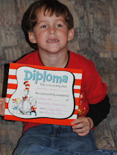 spencer holding his diploma