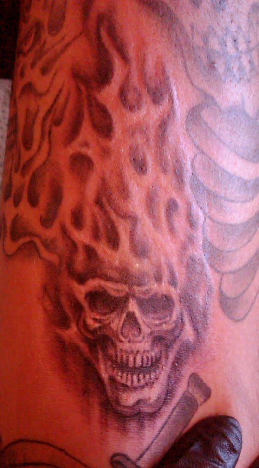 tiny real fire skull done skull tattoo filler. tiny real fire skull done