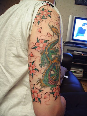  tattoo sleeve consists of cheery blossom tattoo and baby dragon tattoo