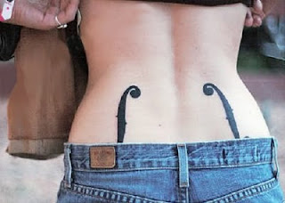 woman with f-hole tattoos