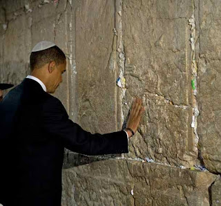 Barack Obama making a wish at the Western wall