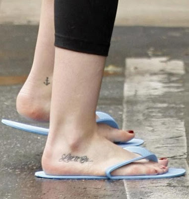 on her right foot and a small anchor on her left ankle