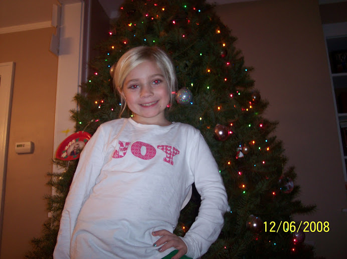 Hannah posing while decorating the tree