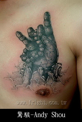 A hand tattoo with Prayer beads breaking through the ground.