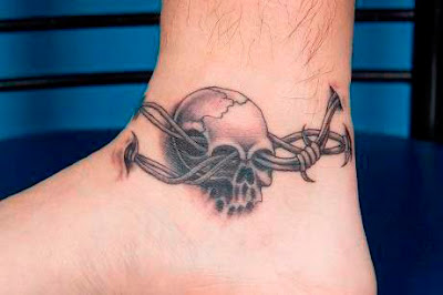 An ankle tattoo with thorn ring going through a skull
