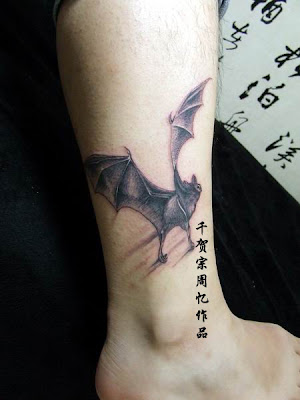 Flying bat tattoo design on the ankle