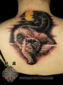 cat tattoo on the back with moon