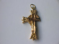 A broken gold cross pendant