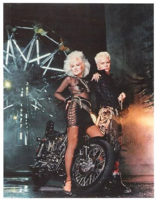 Judi Dozier and Billy Idol, relaxing at home with their Harley Davidson. Probably. Almost certainly.