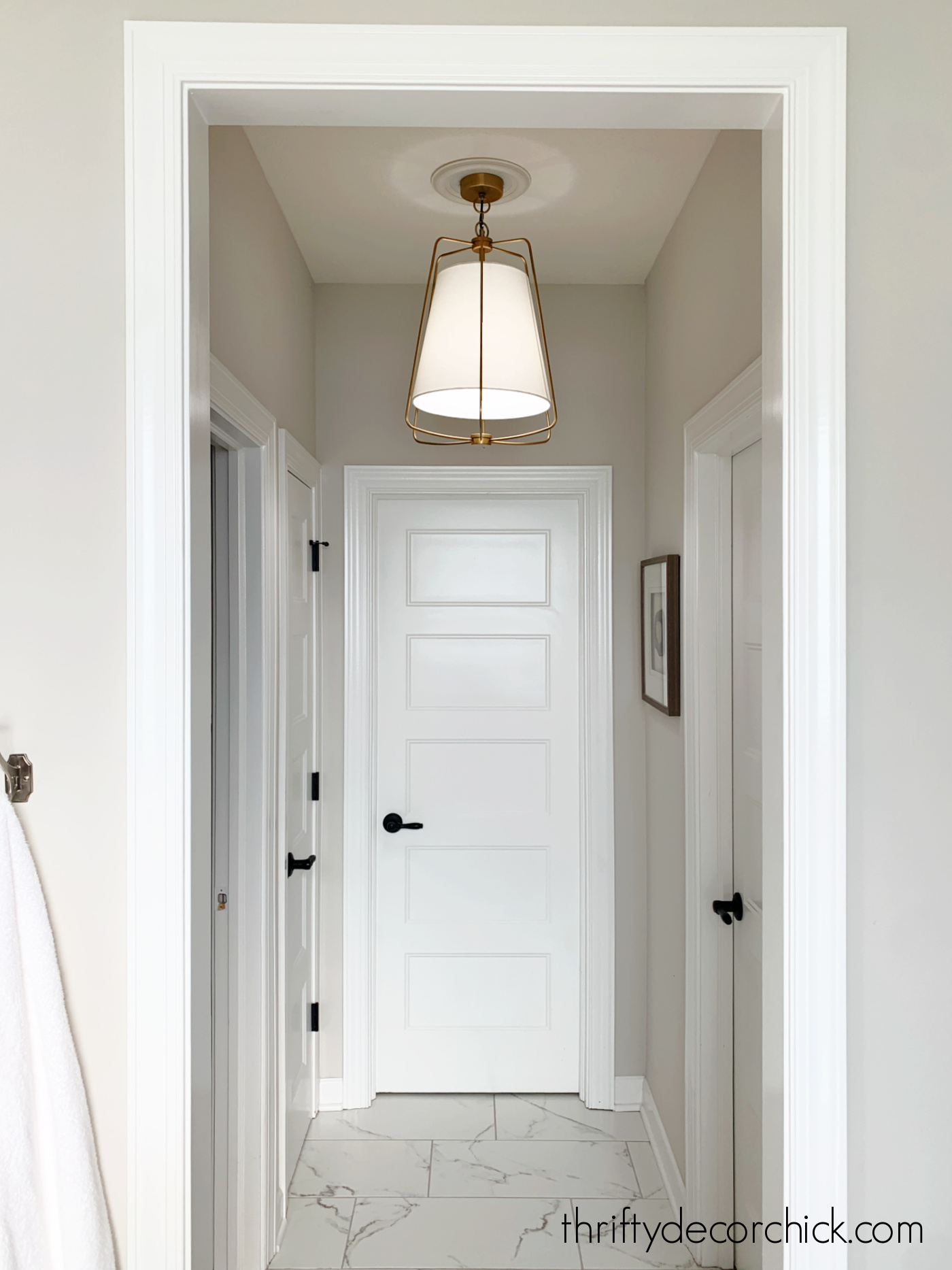 hanging brass light fixture in small hallway