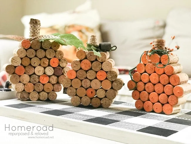 3 wine cork pumpkins on a buffalo check tray