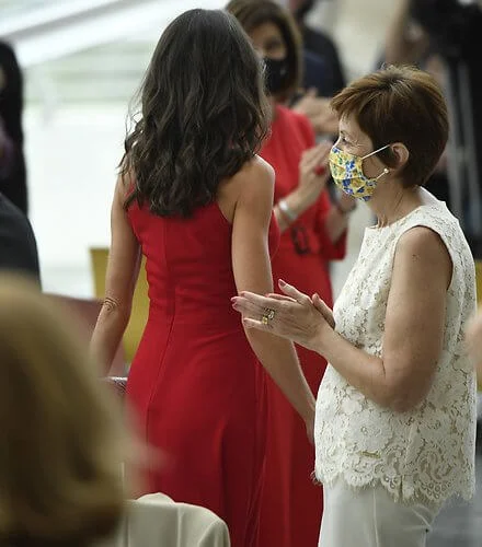 Queen Letizia wore a halter neckline red dress by Carolina Herrera, and nude patent leather slingback pumps, and animal print clutch