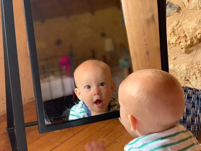 6 month old baby boy looking at his reflection