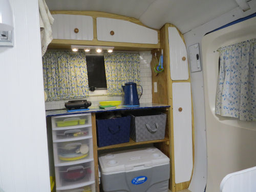 interior of a fiberglass trailer decorated in blue and yellow