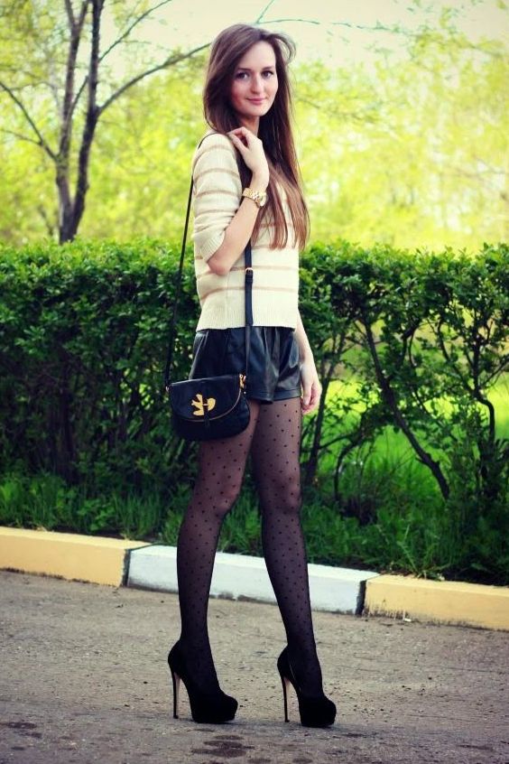 Lovely woman in shorts, polka dot tights and heels