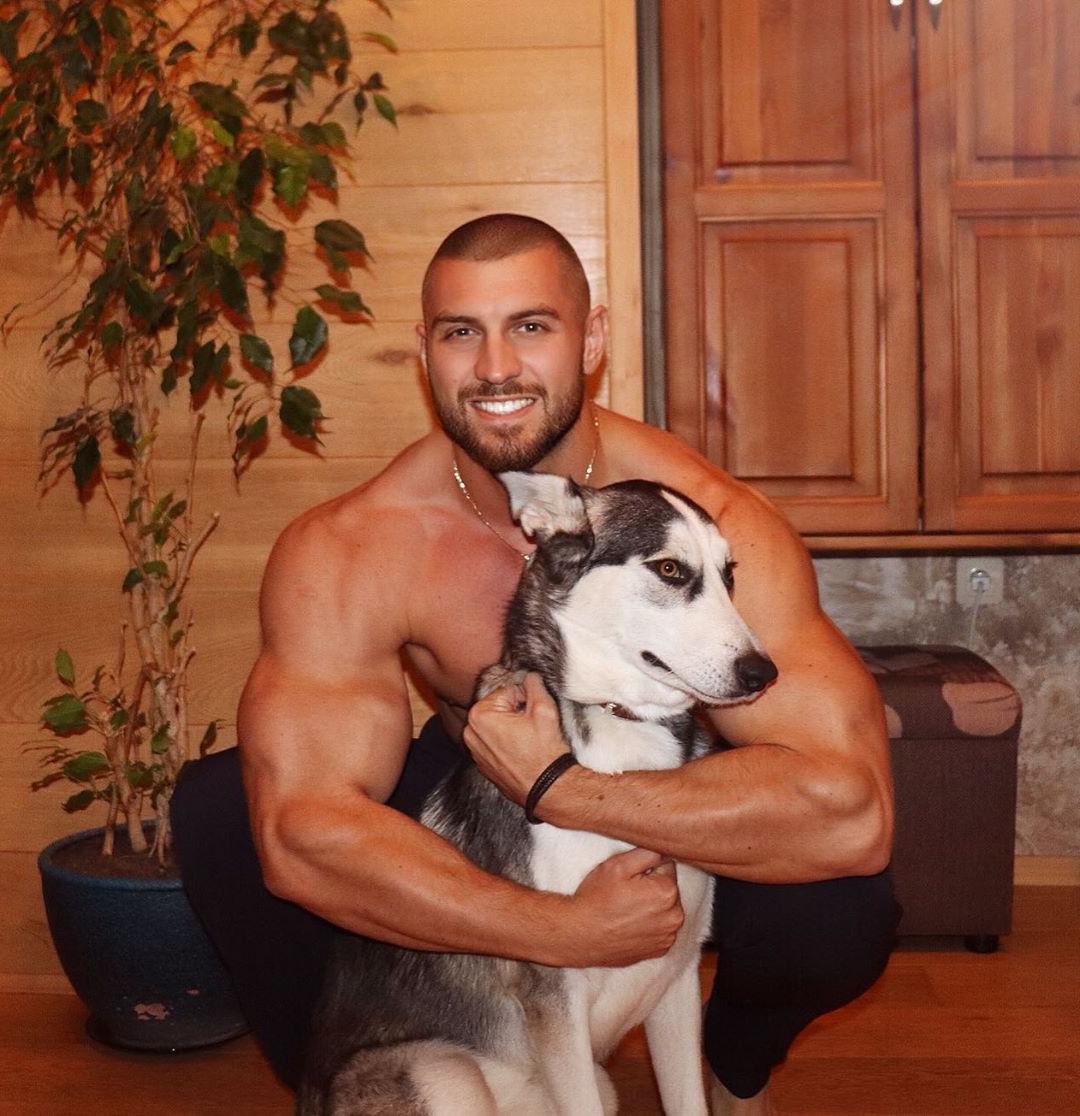 bald-sexy-shirtless-muscle-hunk-hugging-dog-pet