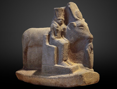 Hathor depicted in the form of a standing cow, flanked by three different forms of Hathor,