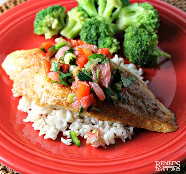 Sweet and Spicy Swai Fillets with Citrus Salsa on a red plate with rice and broccoli 