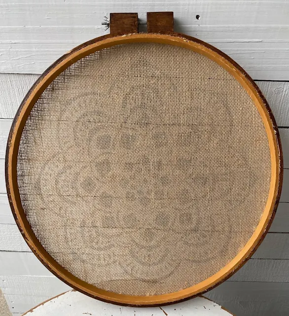 Photo of the back of burlap fabric on quilting hoop