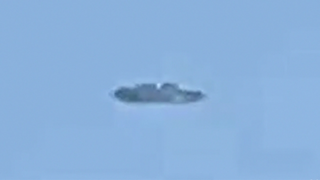 Silver metallic UFO in the shape of a Cigar over Mexico.