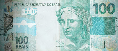 A foto mostra a cédula de 100 Reais o dinheiro do Brasil.Neste embalo de uma economia sólida as pessoas sem fazer planejamento e orçamento familiar compraram a mais do que podiam comprar ou seja foram bem mais além do que ganhavam ou ganham mensalmente. A foto mostra a cédula de 100 Reais o dinheiro do Brasil.