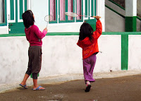 Children playing badminton to beat the cold in Darjeeling