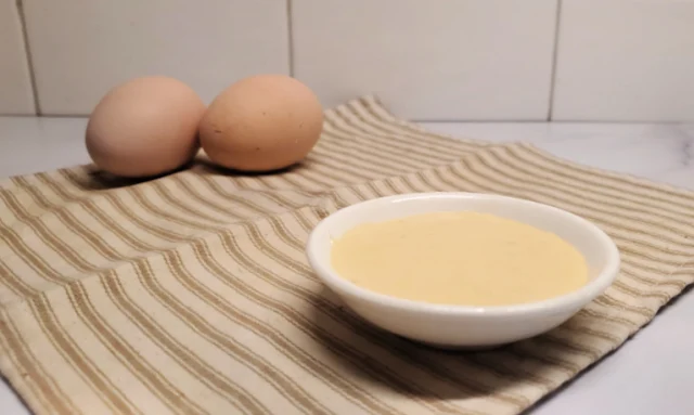 small bowl of dijonnaise sauce on striped towel