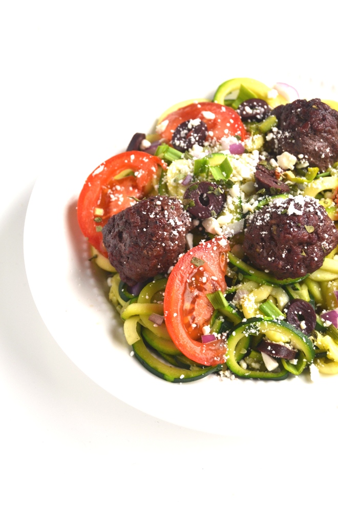 Greek Meatball and Zoodle Bowls are full of flavor and make an easy and filling meal! Zucchini noodles topped with feta cheese, red onions, tomatoes, kalamata olives and homemade meatballs with a lemon vinaigrette! www.nutritionistreviews.com
