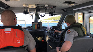 A cadet and ranger at the helm of the patrol boat