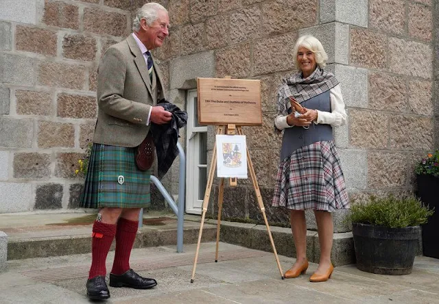 Duchess of Cornwall wore a chic check dress that featured a unique grey waistcoat style top